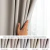 A hand is shown adjusting a light beige curtain, with several swatches of the same curtain fabric shown below under different lighting conditions. Produktbild-Vorschau