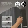 A hand is shown adjusting a grey curtain rod with a grey curtain. Podgląd zdjęcia produktu