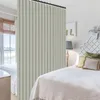 A bedroom scene with a room divider curtain separating two beds. Anteprima dell’immagine prodotto