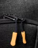 A close-up of a zipper on a black fabric item, with two orange zipper pulls. Produktbild-Vorschau