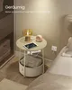 A bedside table with a lamp, tablet, and storage basket in a bedroom setting. Produktbild-Vorschau