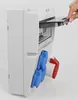 A hand is opening the transparent cover of a gray electrical distribution box with blue and red connectors on the side. Produktbild-Vorschau