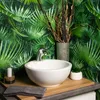 A bathroom sink with a tropical-themed wallpaper. Produktbild-Vorschau