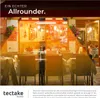 An outdoor seating area of a restaurant with tables and chairs, illuminated by overhead heaters. Náhled obrázku produktu