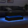A modern coffee table with blue LED lighting in a dimly lit living room. Anteprima dell’immagine prodotto