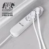 A white power strip with three outlets and two USB ports is shown on a light gray wooden floor, with two white cables plugged into the outlets. Voir les images du produit