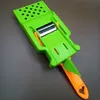 A bright green and orange vegetable slicer is shown on a gray background. Voir les images du produit