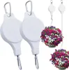 Two white retractable plant hangers are shown, with two hanging baskets of colorful flowers displayed to demonstrate their use. Náhled obrázku produktu