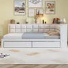 A white daybed with drawers is shown in a bedroom setting with artwork on the wall. Náhled obrázku produktu