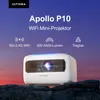 A white ULTIMEA Apollo P10 mini projector is displayed on rocks with a sunset sky in the background. Produktbild-Vorschau