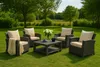An outdoor furniture set with cushions and a coffee table on a grassy lawn with trees in the background. Produktbild-Vorschau