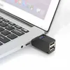 A black USB hub is plugged into the side of a silver laptop. Anteprima dell’immagine prodotto