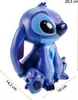 A blue Stitch figurine is shown from the front, sitting down. Dimensions are indicated with lines and text. Produktbild-Vorschau