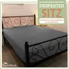 A grey fitted sheet is shown on a bed with a black metal frame. Produktbild-Vorschau