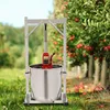 An apple press in an orchard with apple trees in the background. Náhled obrázku produktu