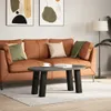 A living room scene with a sofa, coffee table, and artwork. Produktbild-Vorschau
