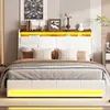 A modern white bed with LED lighting and a wooden headboard is shown in a bedroom setting. Náhľad obrázku produktu