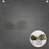 A dark gray privacy screen with a circular inset showing two potted plants. Podgląd zdjęcia produktu