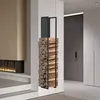 A modern living room with a fireplace and a black metal firewood rack filled with logs. Náhľad obrázku produktu