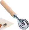 A pasta cutter with a wooden handle and a fluted metal wheel. Produktbild-Vorschau