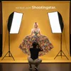 A photographer is taking a picture of a model in a studio with softbox lights. Náhled obrázku produktu