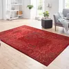 A living room scene with a red rug as the focal point. Produktbild-Vorschau