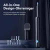 A product shot of an ear cleaning device and its accessories against a dark, draped background. Produktbild-Vorschau