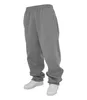 A pair of grey sweatpants with white sneakers. Produktbild-Vorschau