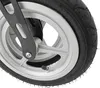 A close-up view of a wheel and part of the frame of a rollator. Náhľad obrázku produktu