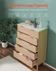 A chest of drawers with several drawers open, displaying organized storage, with decorative items on top. Voir les images du produit