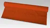 A roll of orange damask tablecloth is shown on a light gray background. Podgląd zdjęcia produktu