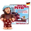 A toy figure of a monkey character named Petzi, standing in front of a book cover featuring the same character and other cartoon animals. Produktbild-Vorschau