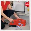 A person is cleaning up broken pieces of something with a dustpan and brush. Produktbild-Vorschau