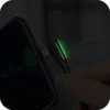 A hand is holding a black USB-C cable with a 90-degree angle connector, which is plugged into a smartphone. The connector has a green LED light indicating charging. Anteprima dell’immagine prodotto