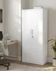 A white metal storage cabinet with two doors and a lock is shown in a home office setting next to a desk and chair. Produktbild-Vorschau