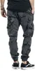 A person wearing camouflage cargo pants and sneakers, shown from the back. Produktbild-Vorschau