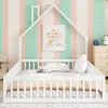 A child's bed with a house-shaped frame, decorated with a framed picture and set against a striped wallpaper. Produktbild-Vorschau