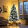 A decorated Christmas tree with lights and presents in a living room setting. Produktbild-Vorschau