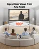 Four people are sitting on a curved sofa watching a projection screen in a living room. The screen displays a scene of a man on a beach. Voir les images du produit
