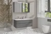 A modern bathroom with a wall-mounted vanity, mirror cabinet, and toilet. Náhled obrázku produktu