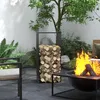 An outdoor patio scene with a fireplace, firewood rack, and seating. Produktbild-Vorschau