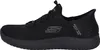 A side view of a black Skechers slip-on shoe. Voir les images du produit