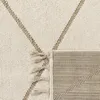 A close-up view of a rug with a geometric pattern and tassels. Anteprima dell’immagine prodotto