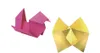 Two origami figures, one pink and one yellow, are shown against a white background. Voir les images du produit