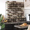 A large wooden wine rack filled with bottles of wine, placed on a countertop next to a kitchen appliance and a bowl of fruit. Produktbild-Vorschau