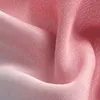 A close-up view of pink and gray gradient fabric, showing its texture and folds. Produktbild-Vorschau