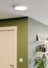 A modern interior scene featuring a ceiling light, a door, and shelves with decorative items. Produktbild-Vorschau