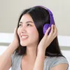 A young woman wearing purple headphones and a gray t-shirt. Náhľad obrázku produktu