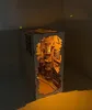 A wooden miniature model of Diagon Alley, lit from within. Produktbild-Vorschau