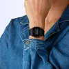 A close-up shot of a person wearing a black digital watch on their wrist, with a denim jacket visible. Anteprima dell’immagine prodotto